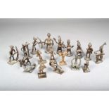 Sixteen brass figural gold weights, Ivory Coast, modelled performing various activities, 9.2cm