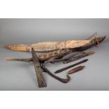 An Oceanic model canoe, the dug-out body with woven reed decking, 112cm long, a Papua New Guinea