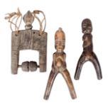 A Lobi catapult, Burkina Faso, the seated figure handle with a ribbed cresting, 19cm high, a Lobi
