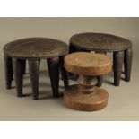 A Nupe stool, Nigeria, with a geometric carved circular top, with ten legs, 21cm high, another