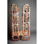 A pair of New Ireland mask panels, Melanesia, carved wood with polychrome decoration, with a bird