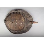 A Sudan shield, with an African softshell turtle shell and wood handle, 46cm high. Provenance Ex Old