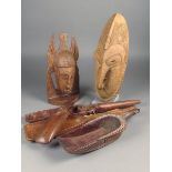 Three Tami Island spoons, Papua New Guinea, carved masks and a bird, the longest 16cm, a Kilenge