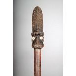 A Maori taiaha, quarter staff, carved Janus tiki with shell eyes and red wax, with scroll and