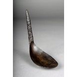 A Northwest Coast horn spoon, the tapering handle carved with totemic masks, 17.5cm long. Provenance