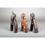 Three Senufo heddle pulleys, Ivory Coast, each carved with a bird head, one with a reel and