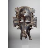 A Senufo kpelie mask, Ivory Coast, carved wood, 25cm high. Provenance Begue collection.