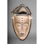 A Gabon mask, with triple part coiffure with incised decoration, the forehead with three nodules,