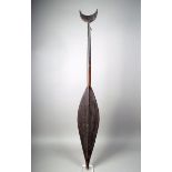 A Borneo paddle, with a leaf shape blade, with bulbous tip, with a banded shaft and fish tail