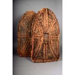 Two Cameroon hide shields, of arch form, with moulded decoration and red pigment, the reverse with