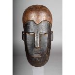 A Tanzanian mask, with black stained face, 29.5cm high.