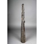 A Sepik trumpet, Papua New Guinea, carved wood with circular raised mouthpiece, the terminal with