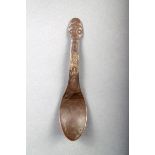 A Hiada silver 'penny' spoon, with incised decoration to the front of the handle, with mask and