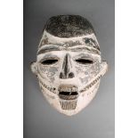 A Nigerian mask, carved wood with kaolin finish, 19cm high. Provenance Collection of the French