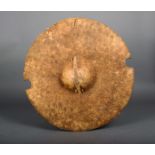 A Sudan hippopotamus / elephant hide shield, circular with a central boss and semi circles cut