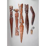 Three Marquesas Islands carved wood daggers, an axe with stone head, 46.5cm long, a carved bone mask