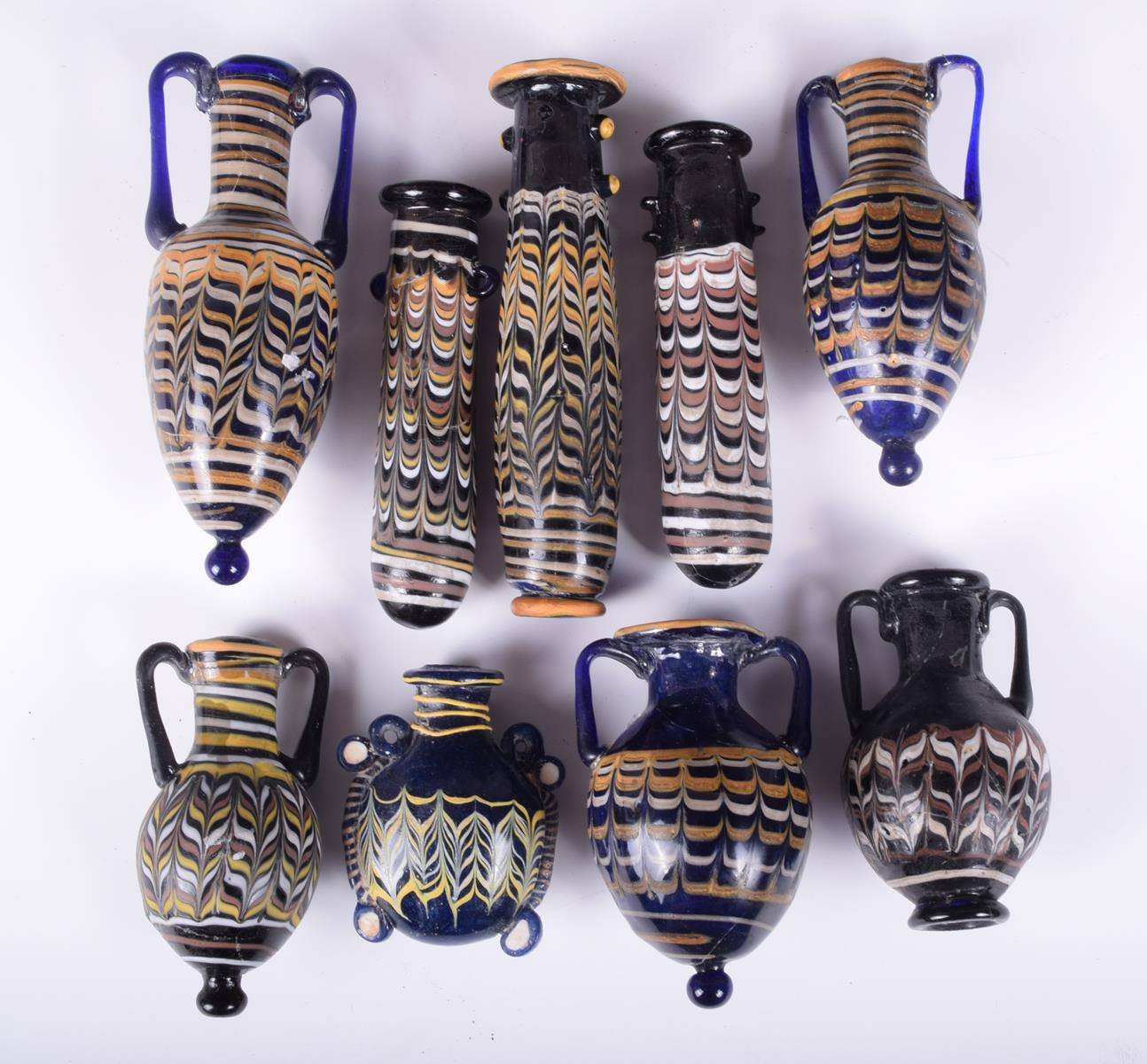 Nine core formed type glass vessels; five amphora shape, 12.5cm the highest. (9) - Image 2 of 2