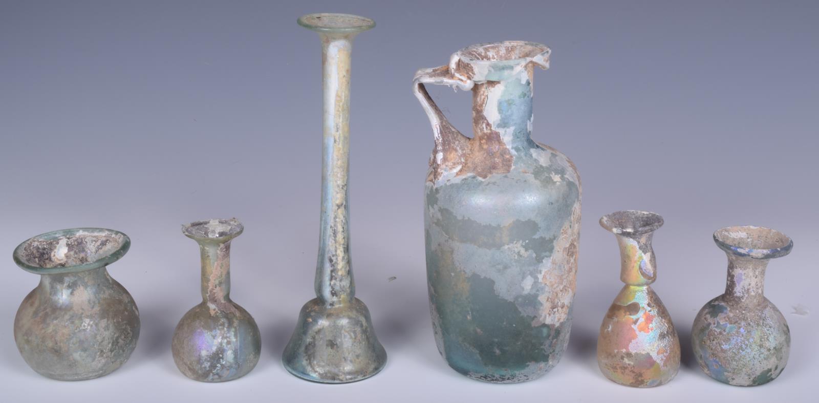 A Roman turquoise glass jug, with strap handle, 15.5cm high, an unguentarium with slender neck and - Image 3 of 3