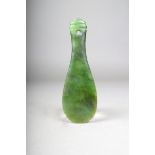 A Maori nephrite patu, with three grooves to the handle and pierced attachment aperture, 17.6cm