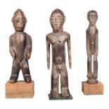 A Lobi standing male figure, Burkina Faso, with open arms, 22cm high, on a stand, a Lobi standing