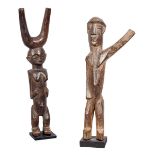 A Lobi standing female catapult figure, Burkina Faso, raised on platforms and with her hands
