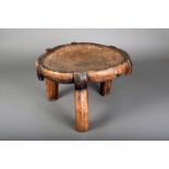 A Hehe stool, Tanzania, the recessed top on three legs with black staining, 25.5cm high.