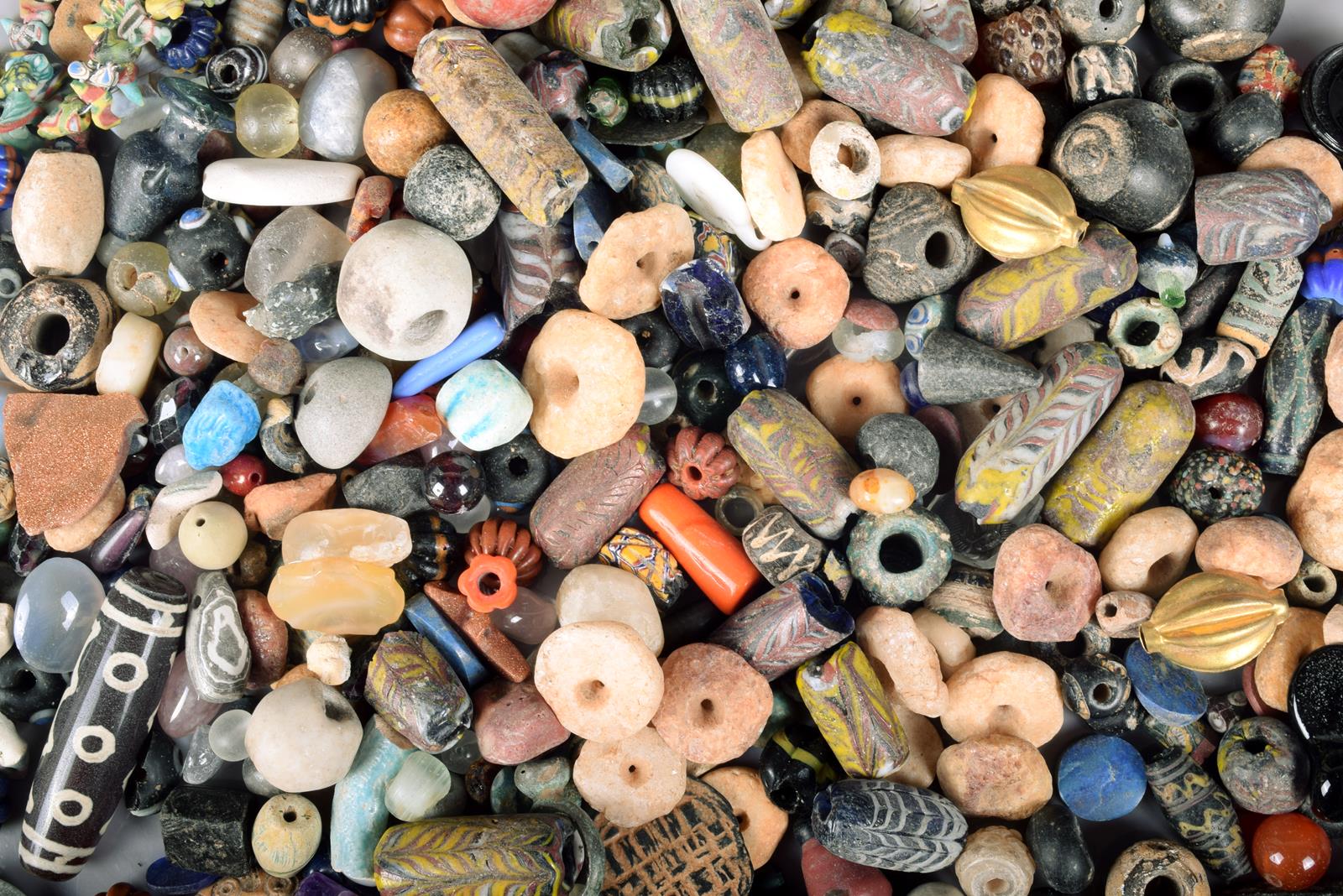 A large collection of glass and stone beads. (a lot)