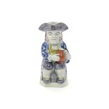 A Wood-type pearlware Toby jug  c.1790, resting a foaming jug of ale on one knee and a small