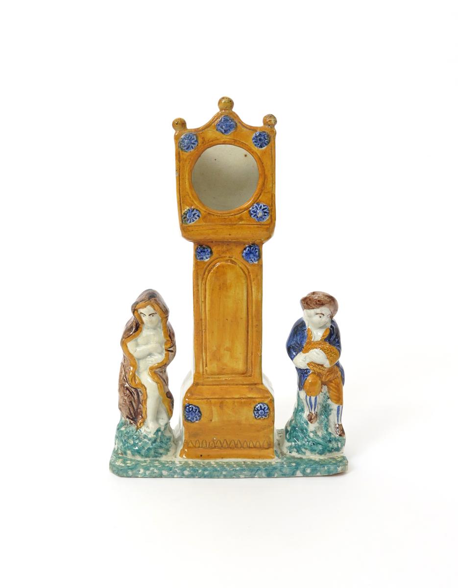 A Pratt ware watch stand  early 19th century, modelled as a longcase clock flanked by two boys