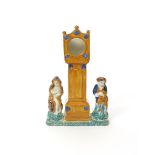 A Pratt ware watch stand  early 19th century, modelled as a longcase clock flanked by two boys