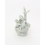 A Tournai white-glazed figure group  c.1770, modelled with three boys playing beneath a tree on a