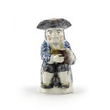 A Wood-type pearlware Toby jug  c.1790, modelled in typical seated pose with foaming jug of ale, a