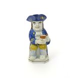 A pearlware Toby jug  c.1800, of Ordinary type, dressed as a sailor with blue striped stockings