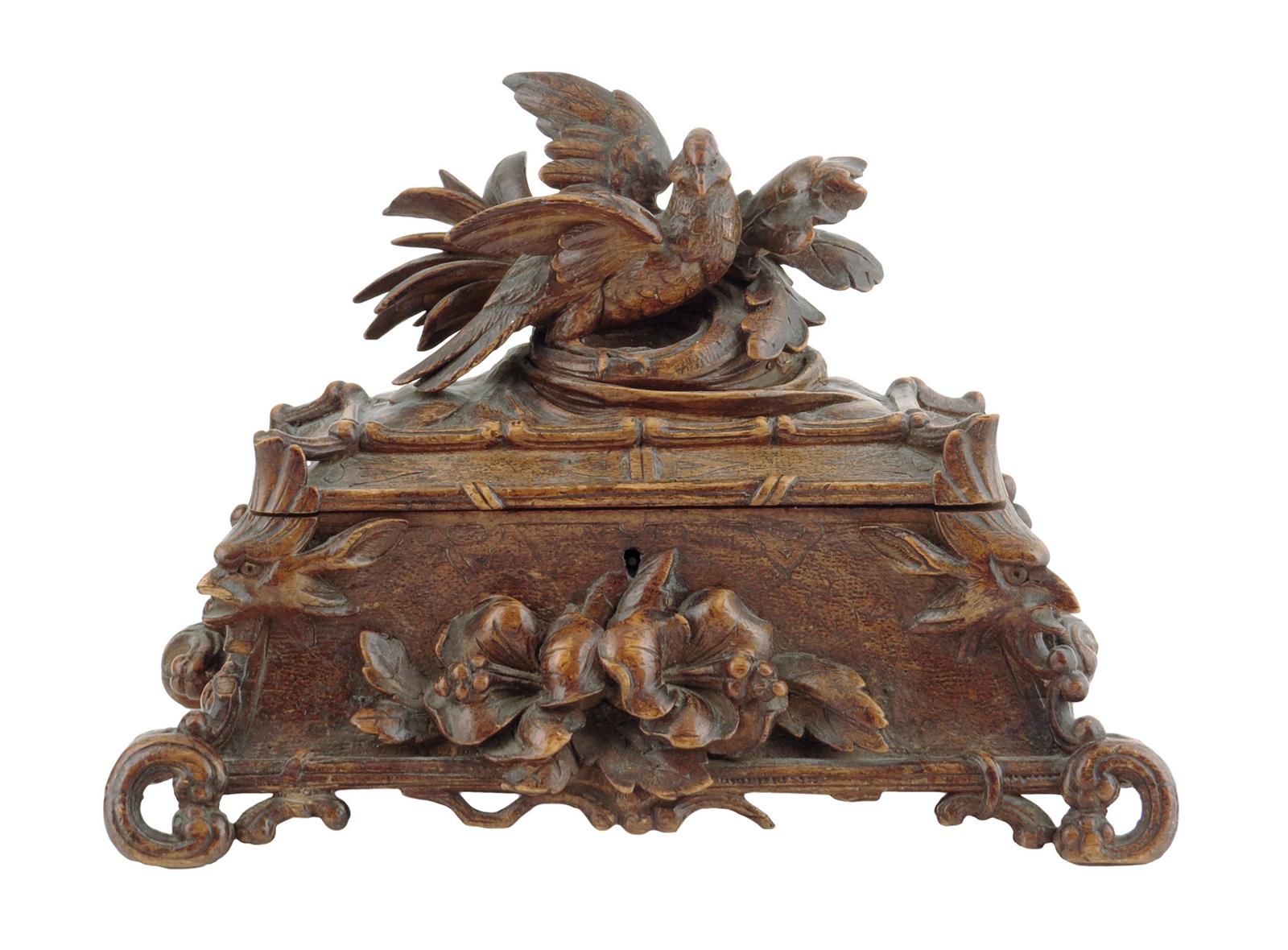 A late 19th century Black Forest jewellery box, carved with an eagle and leaf surmount, the base