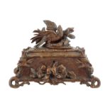 A late 19th century Black Forest jewellery box, carved with an eagle and leaf surmount, the base