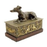 λ A late Regency gilt and patinated bronze inkwell, the lid with a recumbent greyhound revealing a