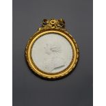 A rare Sèvres biscuit porcelain relief medallion of Louis XV, the French monarch wearing a laurel