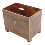 A walnut tea caddy, with boxwood stringing, the interior with a single lidded compartment, on disc