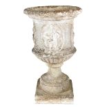 A large composition stone garden urn, decorated with oval panels of classical figures, on a socle