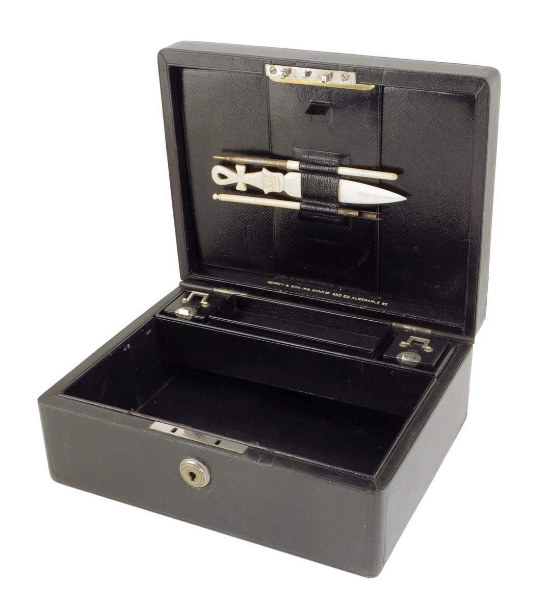 An early 20th century black leather writing box by Asprey, the hinged lid with a sunken brass handle