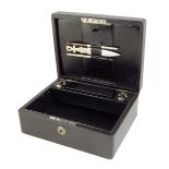 An early 20th century black leather writing box by Asprey, the hinged lid with a sunken brass handle