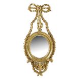 A giltwood girandole, with an oval plate to a husk and ribbon tied frame, late 19th century, 56.5