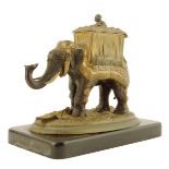 A Victorian gilt and patinated bronze vesta / go to bed, in the form of a caparisoned elephant, on a