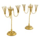 A pair of 19th century gilt metal candleholders, each with three open basket sconces and spiral