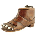 A 19th century treen snuff sandal, the lid with a ring handle and inset with a bone plaque, the