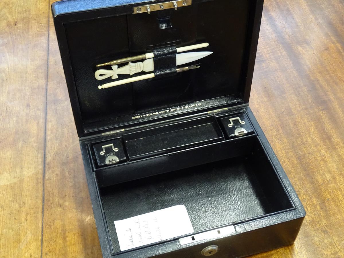 An early 20th century black leather writing box by Asprey, the hinged lid with a sunken brass handle - Image 8 of 13