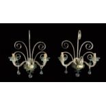 A set of four Venetian glass wall lights, each with a pair of spiral twist scroll arms hung with