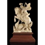 λ A carved ivory group of St. George and the dragon, mounted on a stepped hardwood plinth, early