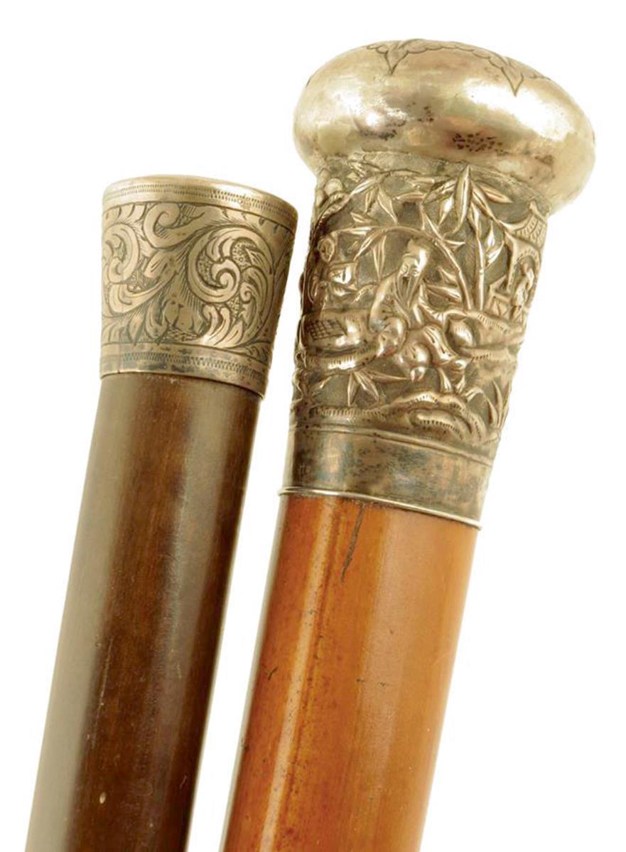 A late 19th century Chinese walking cane, the silver handle engraved with a monogram above figures