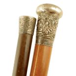 A late 19th century Chinese walking cane, the silver handle engraved with a monogram above figures